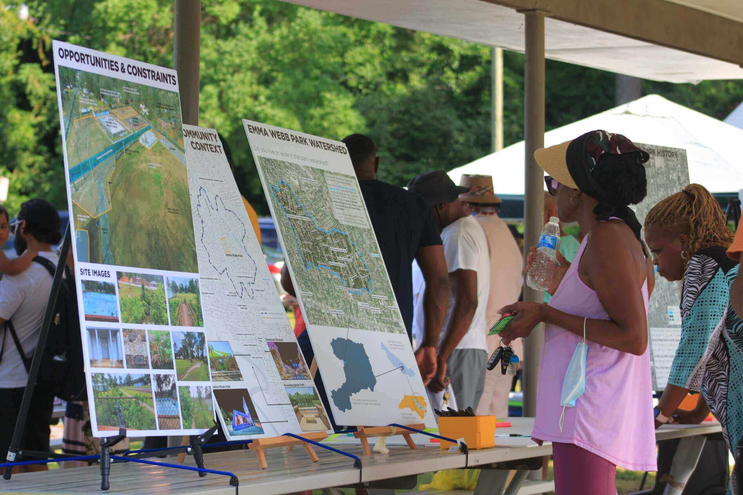 woman looking at posters of park design