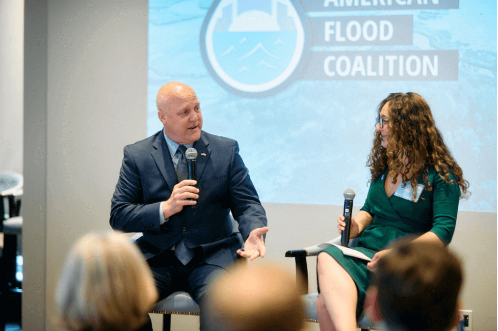 mitch landrieu and melissa roberts seated next to each other