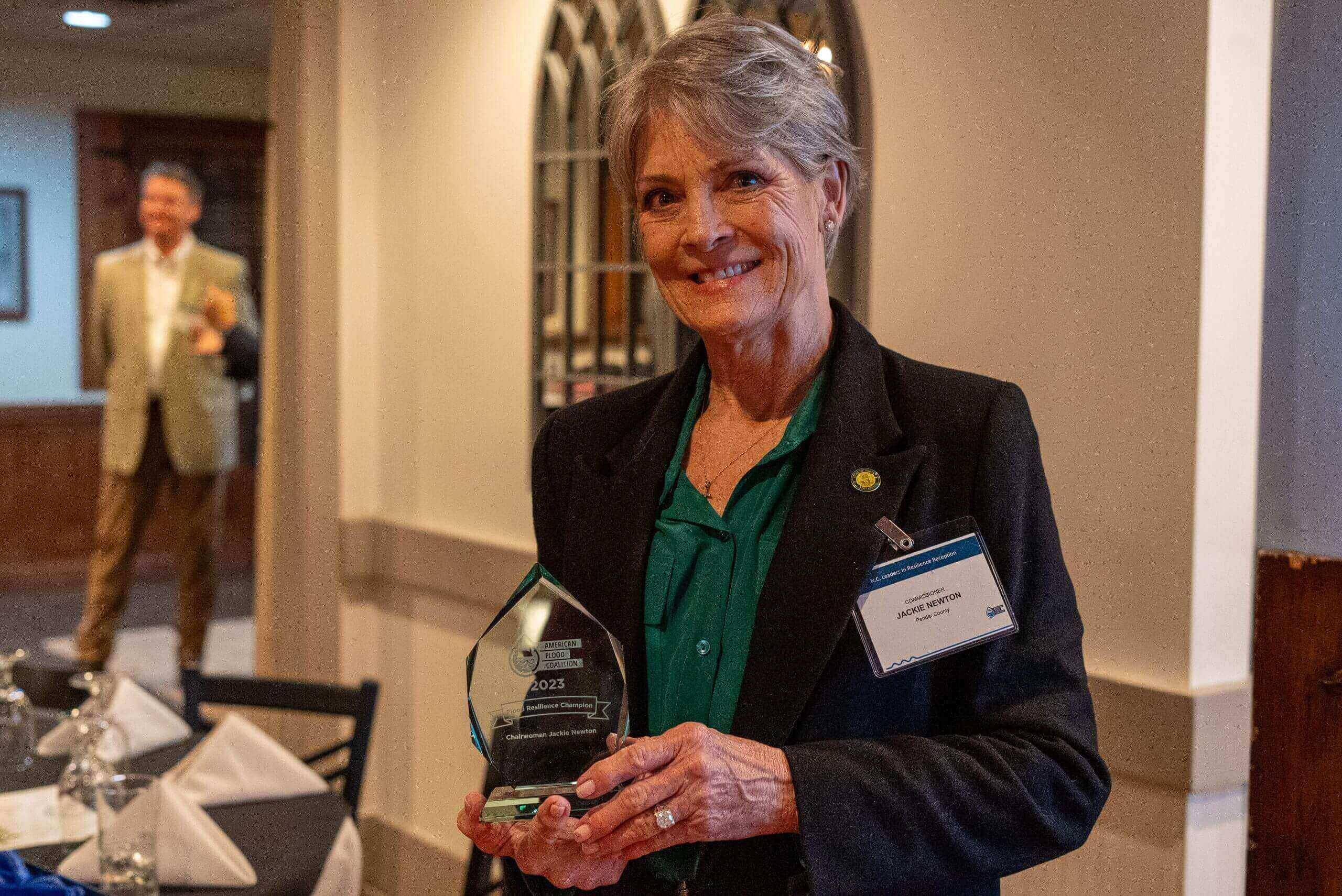 woman holding an award
