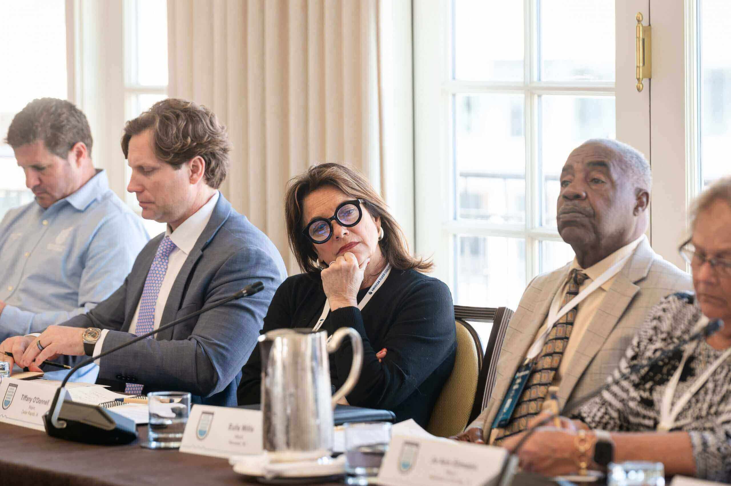 woman listening to others speak at table